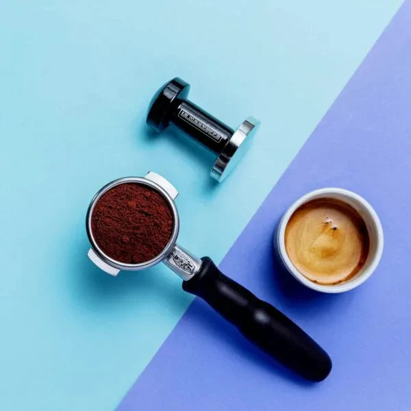A collection of La Marzocco accessories including a tamper, portafilter, and dosing cup