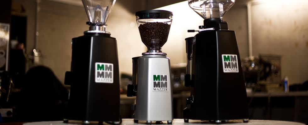 A collection of Mazzer coffee grinders including the mini doser and super jolly
