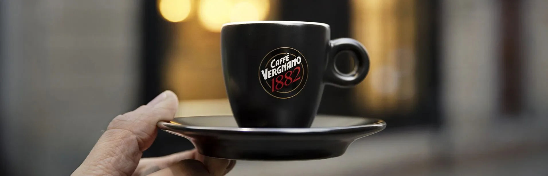 A person holds the iconic caffe vergnano espresso cup