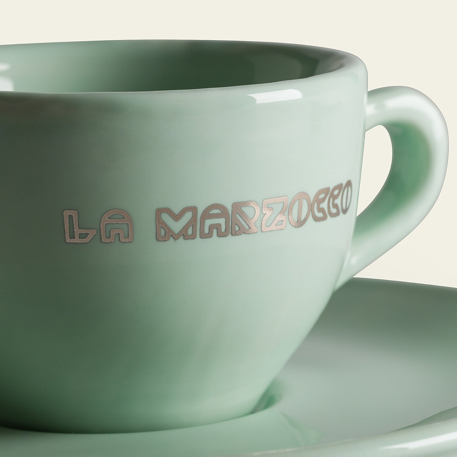 mint green 'La Marzocco' coffee cup and saucer on a light background